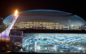 Olympic torch on a background of the stadium at the Olympic Games in Sochi