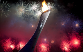 Olympics torch on a background of fireworks at the opening of the Olympic Games in Sochi
