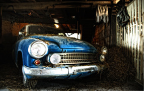 Old car sprinkled hay in the barn