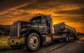 Tractor against a background of an orange sky, photo HDR