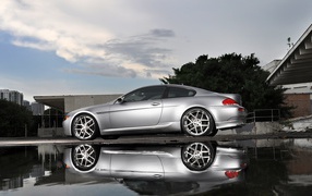 Silver BMW 6 near the water