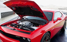 Under the hood of a red Dodge Challenger