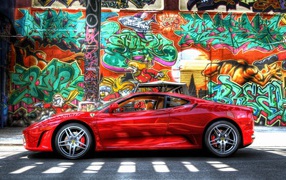 Red Ferrari F430 Scuderia at the wall with graffiti