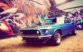 Classic blue Ford Mustang Shelby GT500 at the wall of graffiti