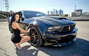 Girl in a black Ford Mustang