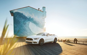 Mustang convertible on the background of the drawing on the building