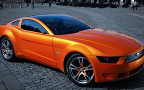 Orange Mustang on a paved town square