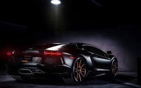Черный Lamborghini в луче прожектора