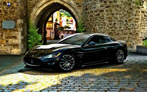 Black Maserati gran turismo in stone arch