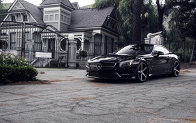 Black Mercedes at the gate of the villa