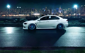 Car Mitsubishi Lancer Evo X against the backdrop of the city
