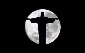 Statue of Christ in Rio on the background of the Moon
