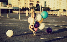 Bunch of balloons in the hands of a young girl