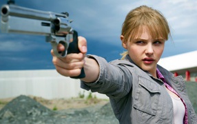 Girl model with a gun in his hand