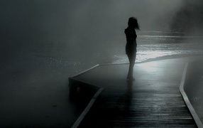 Girl on the dock in the fog