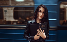 Girl with a book in the subway