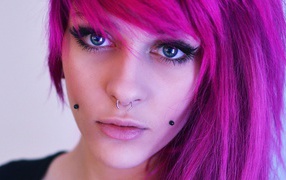 Ring in the nose of a girl with pink hair