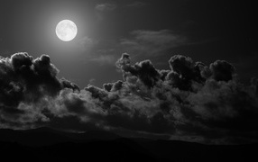 Moon among black clouds