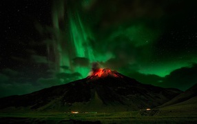 Northern Lights over a flaming volcano