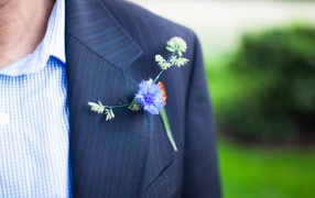 Wild flower in the buttonhole of his jacket