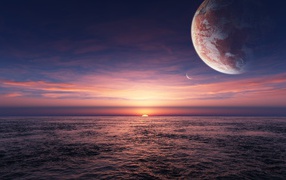 Планета в небе над закатом в океане