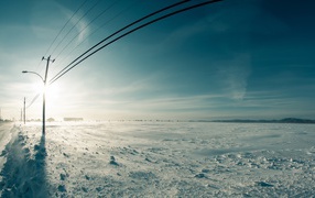 Power line along the snow-covered field