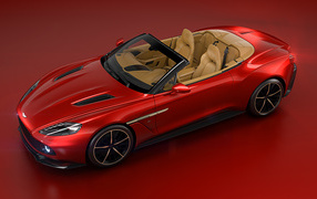 Суперкар Aston Martin Vanquish на красном фоне