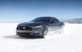 Black car Ford Mustang on the snowy road