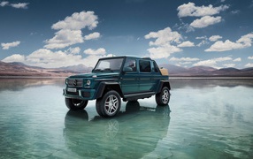 Green car Mercedes-Maybach Landaulet G650, 2018 stands in the water against the sky