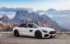 Стильный автомобиль Mercedes-AMG GT Roadster на фоне гор 