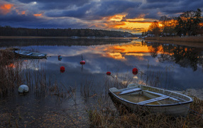 Boats in a quiet forest lake at sunset