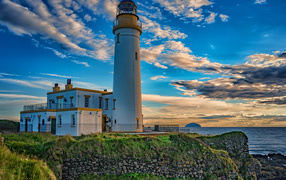 Lighthouse on the coast under a beautiful blue sky