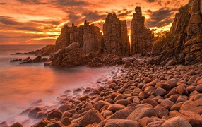 Каменные скалы в океане на закате солнца