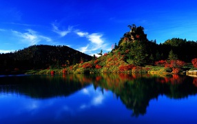 The blue sky is reflected in the clear water of the lake