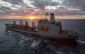 USNS John Lenthall warship, T-AO 189 in the sea at sunset