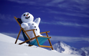 Snowman in a chair on a snowy slope