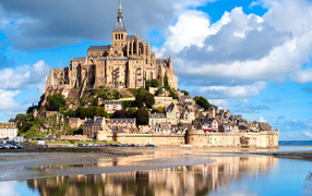 The island of the fortress of Mont-Saint-Michel is reflected in the water, France