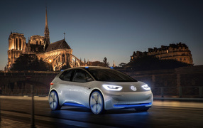 Electric Volkswagen I.D, against the backdrop of an ancient castle