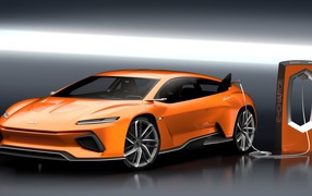 Оранжевый электромобиль GT Zero на заправке