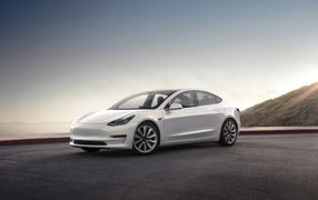 White electric vehicle Tesla Model 3, 2018 on the background of the horizon