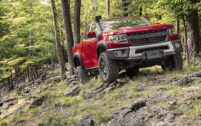 Red SUV Chevrolet Colorado ZR2 Bison, 2019 in the forest