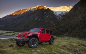 Red car Jeep Wrangler on the background of the mountains