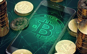Coins bitcoin with a smartphone on the table