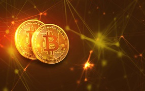 Две золотые монеты биткоин на фоне виртуальных лучей 