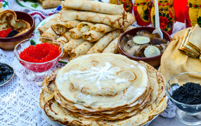 Delicious festive treats with pancakes and caviar on the table for the holiday Maslenitsa