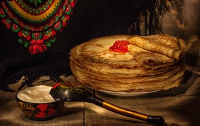 Delicious pancakes with red caviar and sour cream for the Russian holiday Maslenitsa 2019