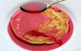 Pancakes with berry syrup on a white background for the Maslenitsa holiday 2018