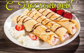 Pancakes with cream and strawberries on a white plate for the holiday of Maslenitsa