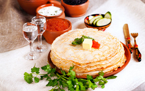 Pancakes with red caviar on the festive table for Pancake week 2018