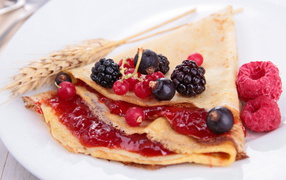 Thin pancakes with jam and fresh berries for Pancake week